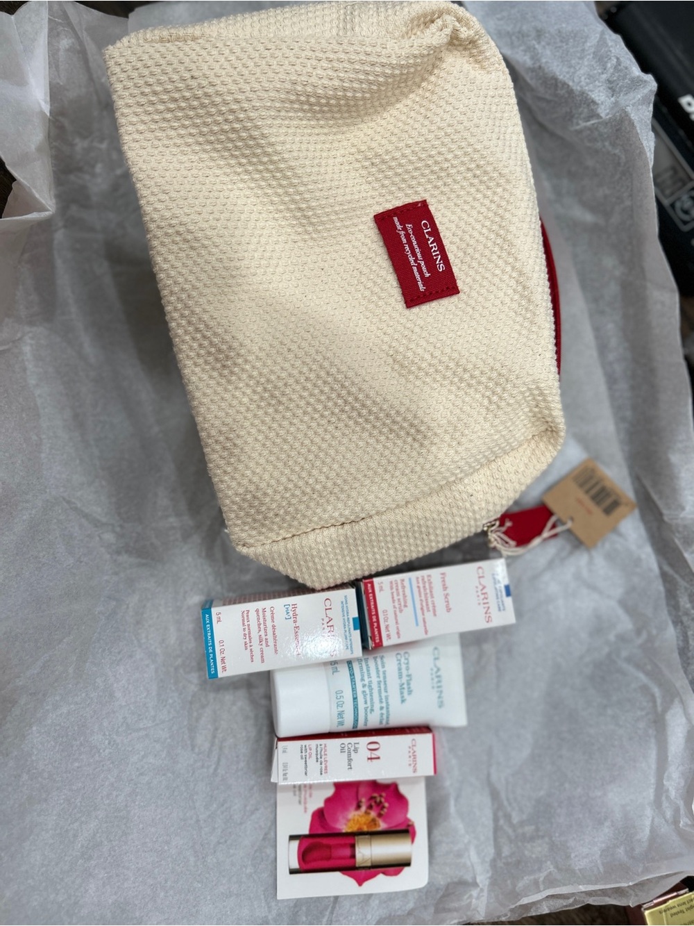 Clarins Cream Textured Cosmetic Pouch with Red Logo Accent